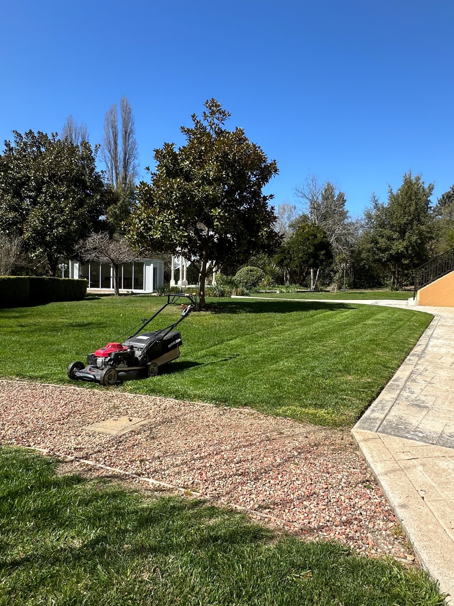 Mower on a freshly striped lawn in a large established garden